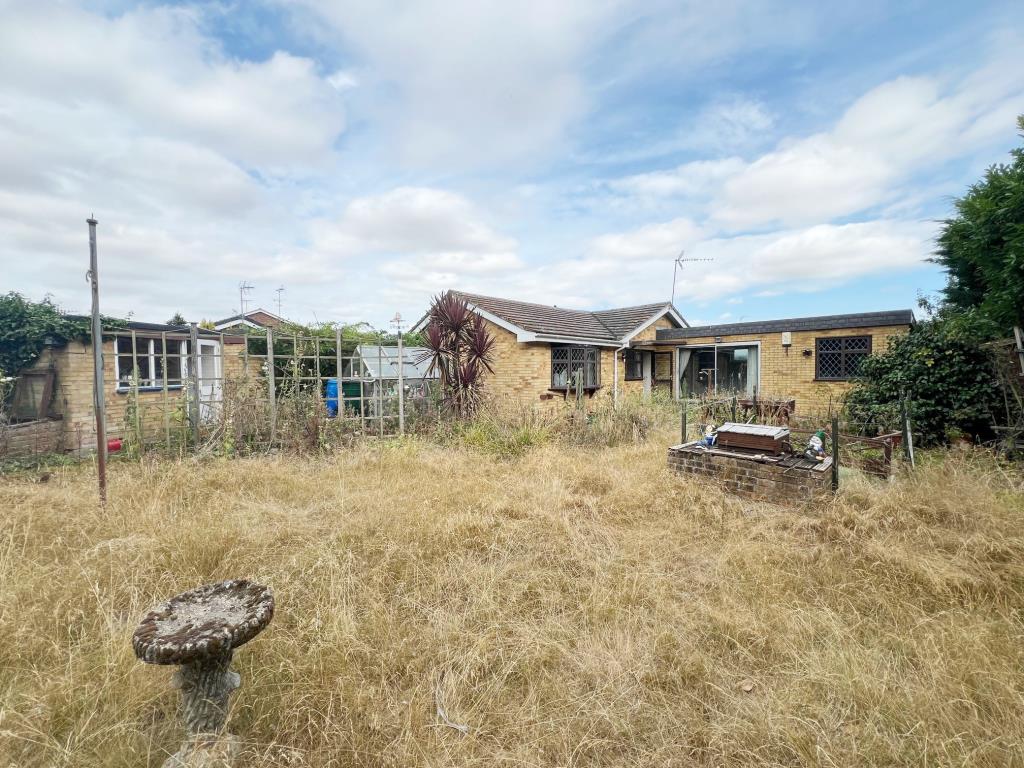 Lot: 66 - DETACHED BUNGALOW FOR REFURBISHMENT - Rear aspect of bungalow showing storage/tool shed